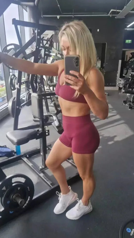 Rainy taking a mirror photograph of herself at the gym
